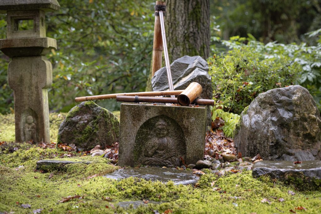 Japanse Tuin in de herfst. Oriantaalse lantaarns, beeldjes, stenen.